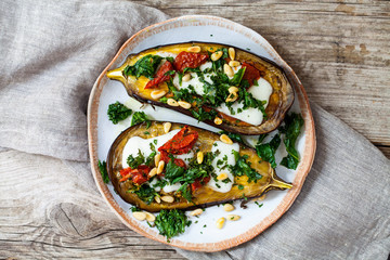 Roast aubergine with goat cheese, sun dried tomatoes, crispy kale and pine nuts