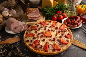 Pizza with ham and smoked sausages for a restaurant menu.