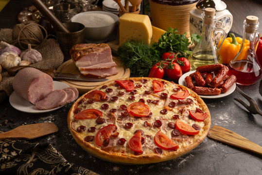 Pizza with ham and smoked sausages for a restaurant menu.