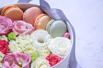 round Box with flowers and almond cookies on marble background