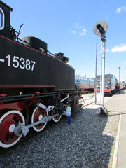 Little curious boy explore old steam locomotive