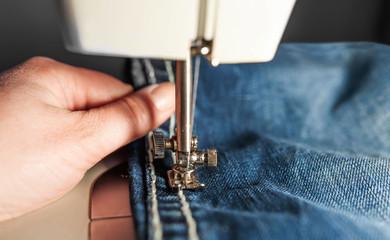 The sewing process. Sewing female hands. sewing industry workshop