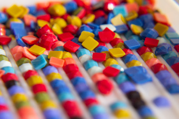 the background is multi-colored square elements of diamond mosaic.