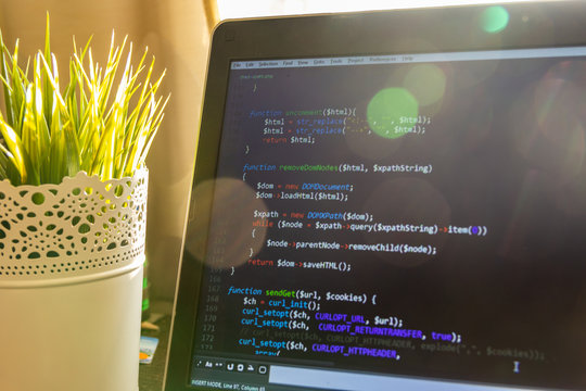 Abstract web developer background. PHP scraper code in sun light - Powered by Adobe