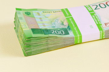 Dvuhmatchevyh bundle of banknotes in the banking package lies on the yellow table