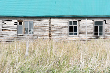 Fototapeta na wymiar Abandoned Wooden House with Broken Windows
