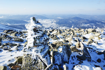 Stones in the snow on top of a hill