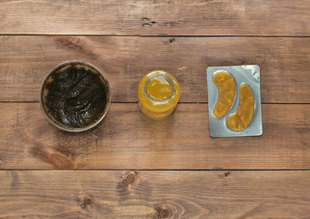 Flatlay view spa cosmetics products for face and body on wooden background