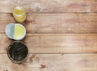 Flatlay view spa cosmetics products for face and body on wooden background