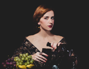 Portrait of beautiful rich women with grapes.