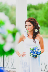 Portrait of young bride with flower bouquet.