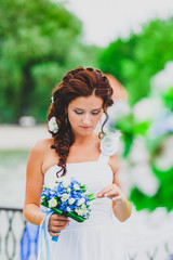Portrait of young bride with flower bouquet.