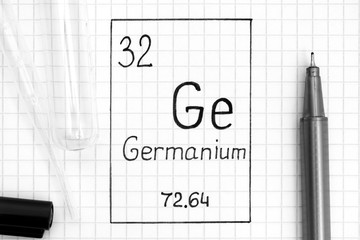 Handwriting chemical element Germanium Ge with black pen, test tube and pipette.