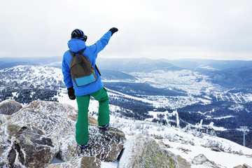 Traveler at the top of the mountain. View from the back