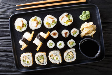 Delicious Japanese sushi rolls large set with seafood, vegetables, tofu and tamago closeup. horizontal top view