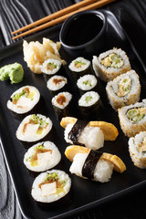 set of Japanese rolls sushi Hosomaki, Uramaki, Maki, Nigiri, Tamagoyaki served with ginger, wasabi and soy sauce close-up. horizontal