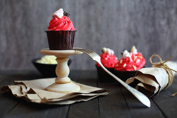 cupcakes with red cream on grey background