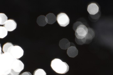 bokeh effect of glossy highlights on black texture - beautiful abstract photo background