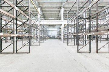 Interior of empty warehouse with empty racks