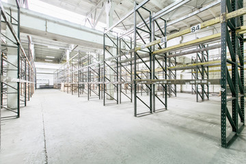 Interior of empty warehouse with empty racks