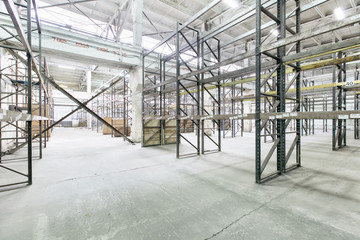 Interior of empty warehouse with empty racks