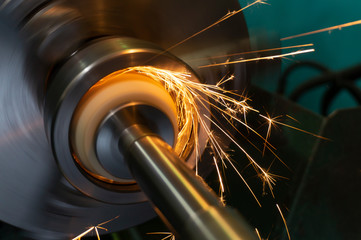 Internal processing of the hole with an abrasive stone on a grinding machine, sparks fly in...