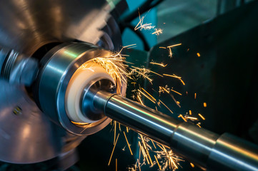 Internal processing of the hole with an abrasive stone on a grinding machine, sparks fly in...