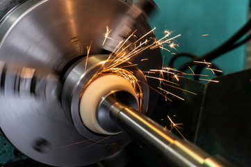 Internal processing of the hole with an abrasive stone on a grinding machine, sparks fly in...