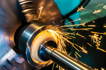 Internal processing of the hole with an abrasive stone on a grinding machine, sparks fly in...