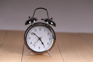 The old alarm clock on a light background