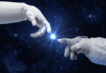 Hand of astronaut and robot. Contact with other civilizations. © revers_jr