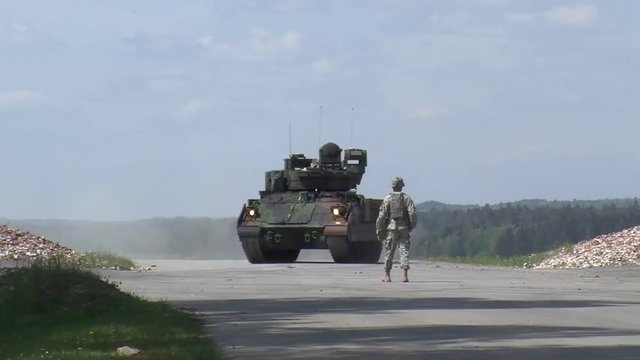 Soldier giving directions and instructions to the tank users.