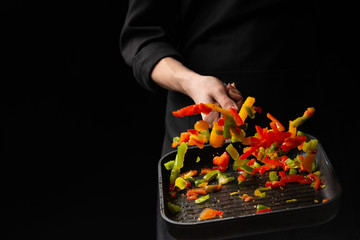 Professional chef. cooks vegetables in a pan, Asian cuisine. Oriental. background for the menu. recipe book