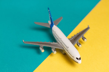 Flat lay airplane on yellow background