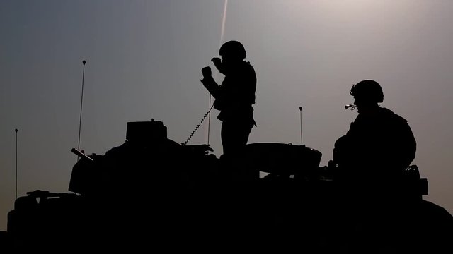 Group of tank operators hanging out outside the tanks.