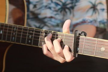 Fototapeta na wymiar Man’s hand playing acoustic guitar,Close up left hand
