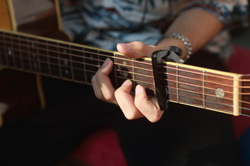 Obraz na płótnie Canvas Man’s hand playing acoustic guitar,Close up left hand