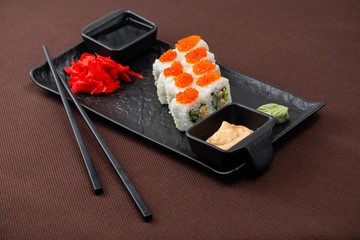 sushi on a black plate