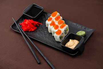 sushi on a black plate