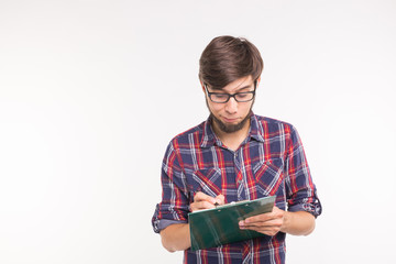 People, business and student concept - surprised young man writing on clipboard on white background with copy space