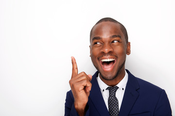 Close up happy african american businessman smiling with finger pointing up