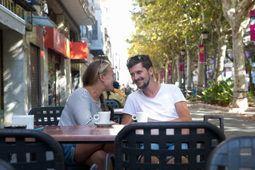 Two young people drink coffee