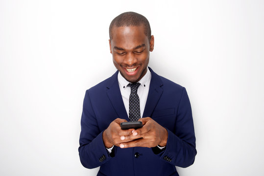 smiling african american businessman on white background looking at mobile phone