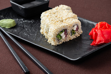 sushi on a black plate