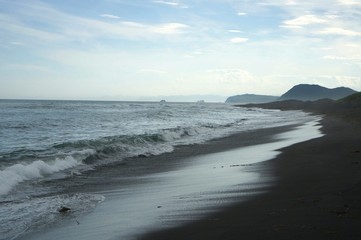 Fototapeta na wymiar black sand on the Pacific coast of Kamchatka