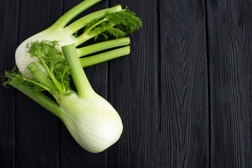 Fennel on the black  wooden background.Top view.Copy space.