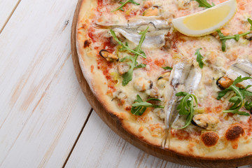 Delicious spicy Italian food, pizza with anchovies and gherkins, hot piquant meals for foodie