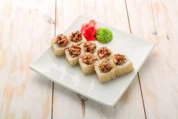 Japanese sushi roll topped with spicy salmon slice