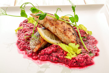 Fried fish fillet of perch with mashed beet and potato, elegant dinner