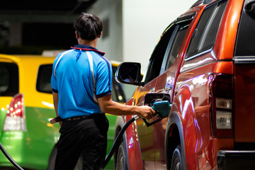 Hand refilling the fuel at the refuel station.